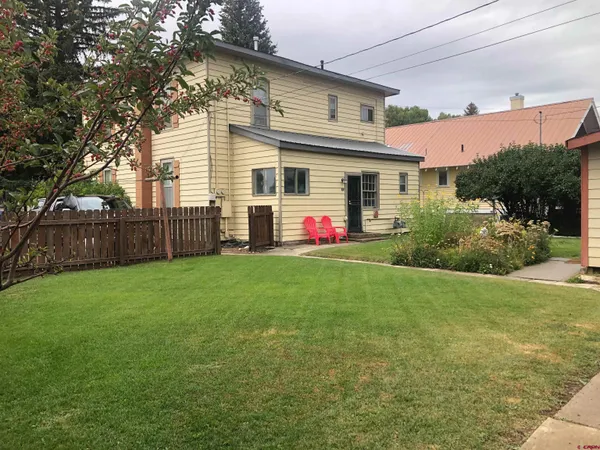 a front view of house with yard and green space