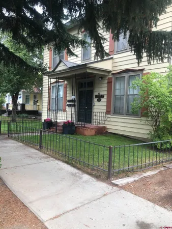 a view of a house with a garden and plants