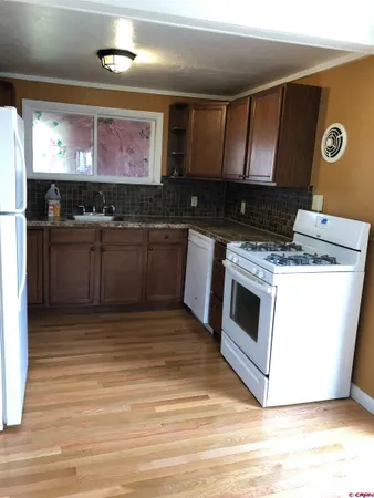 a kitchen with stainless steel appliances granite countertop a stove and a microwave