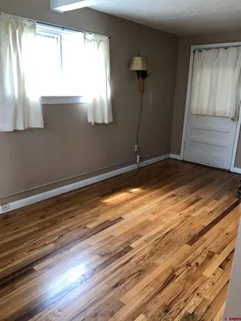 a view of room with window and hardwood floor