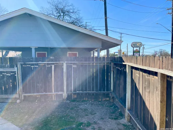 a view of a house with wooden fence