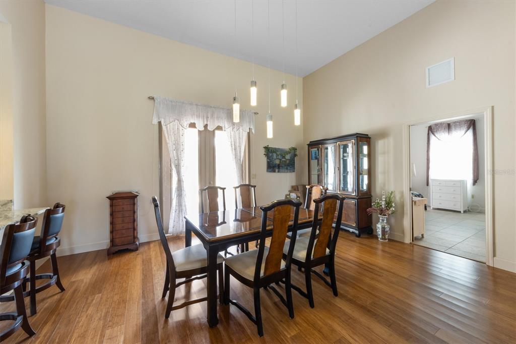 3310 Twin Rivers Trail Parrish, FL 34219 - Photo 14 of 42 a dining room with furniture and wooden floor