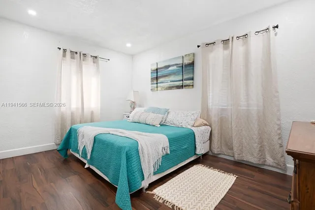 a bedroom with a bed and a mirror