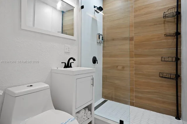 a bathroom with a toilet sink and shower