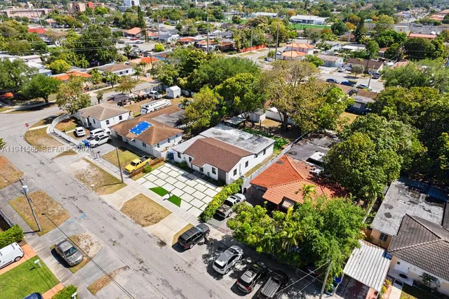 an aerial view of a house with a yard and lake view