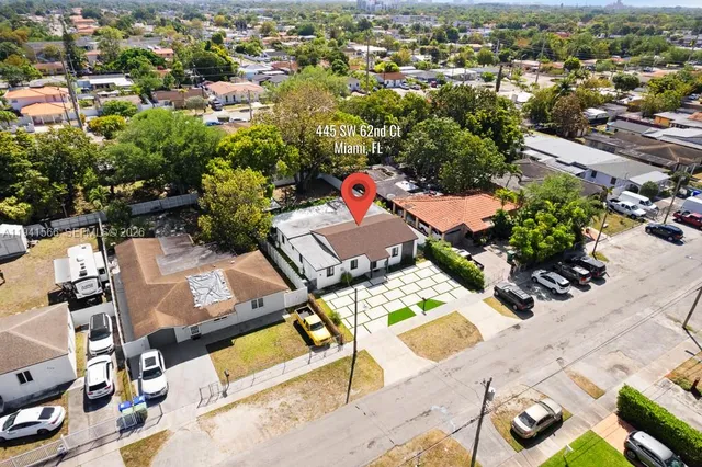 an aerial view of a residential houses with yard