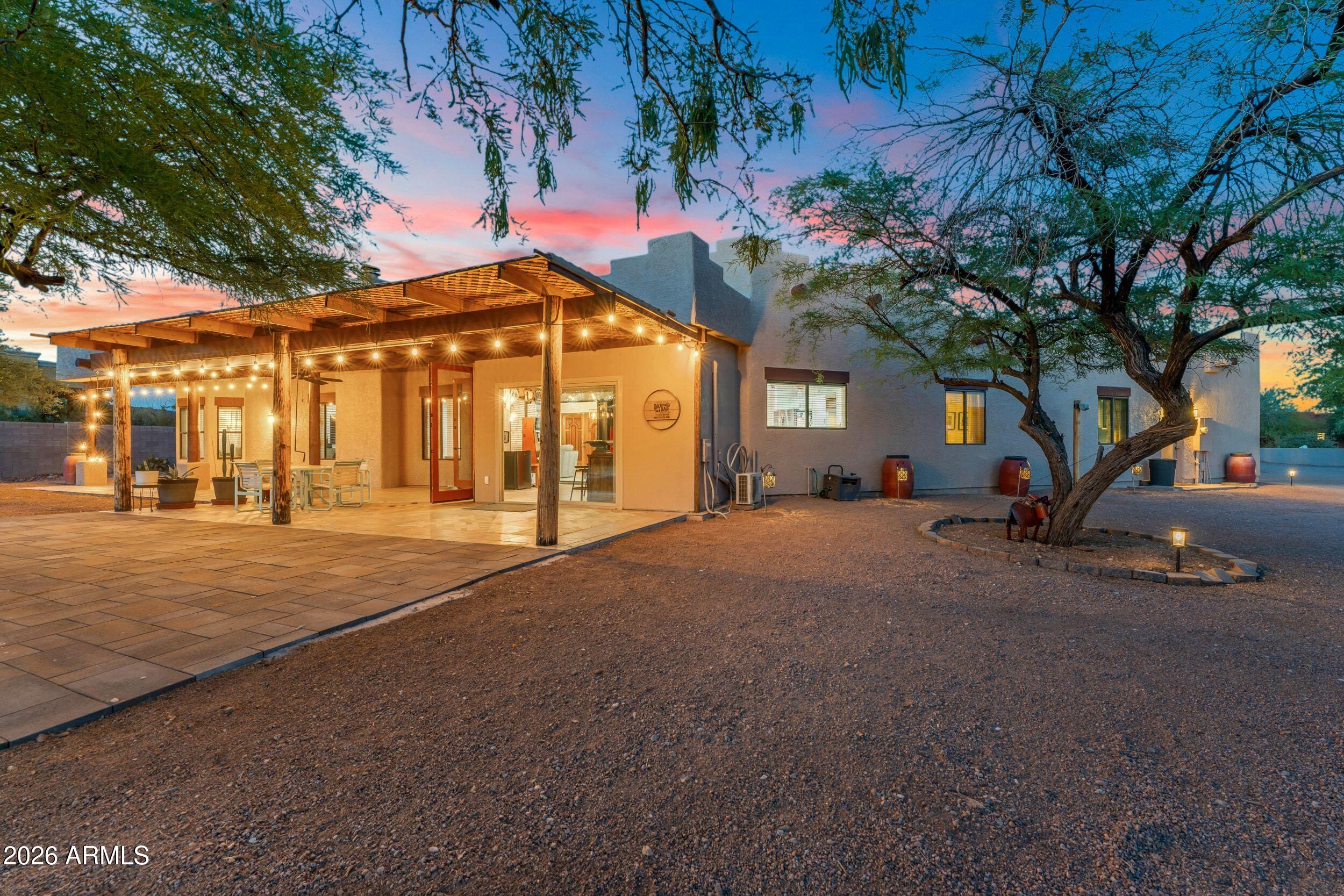 4284 North Colt Road Apache Junction, AZ 85119 - Photo 14 of 92 a porch with a table and chairs under an umbrella