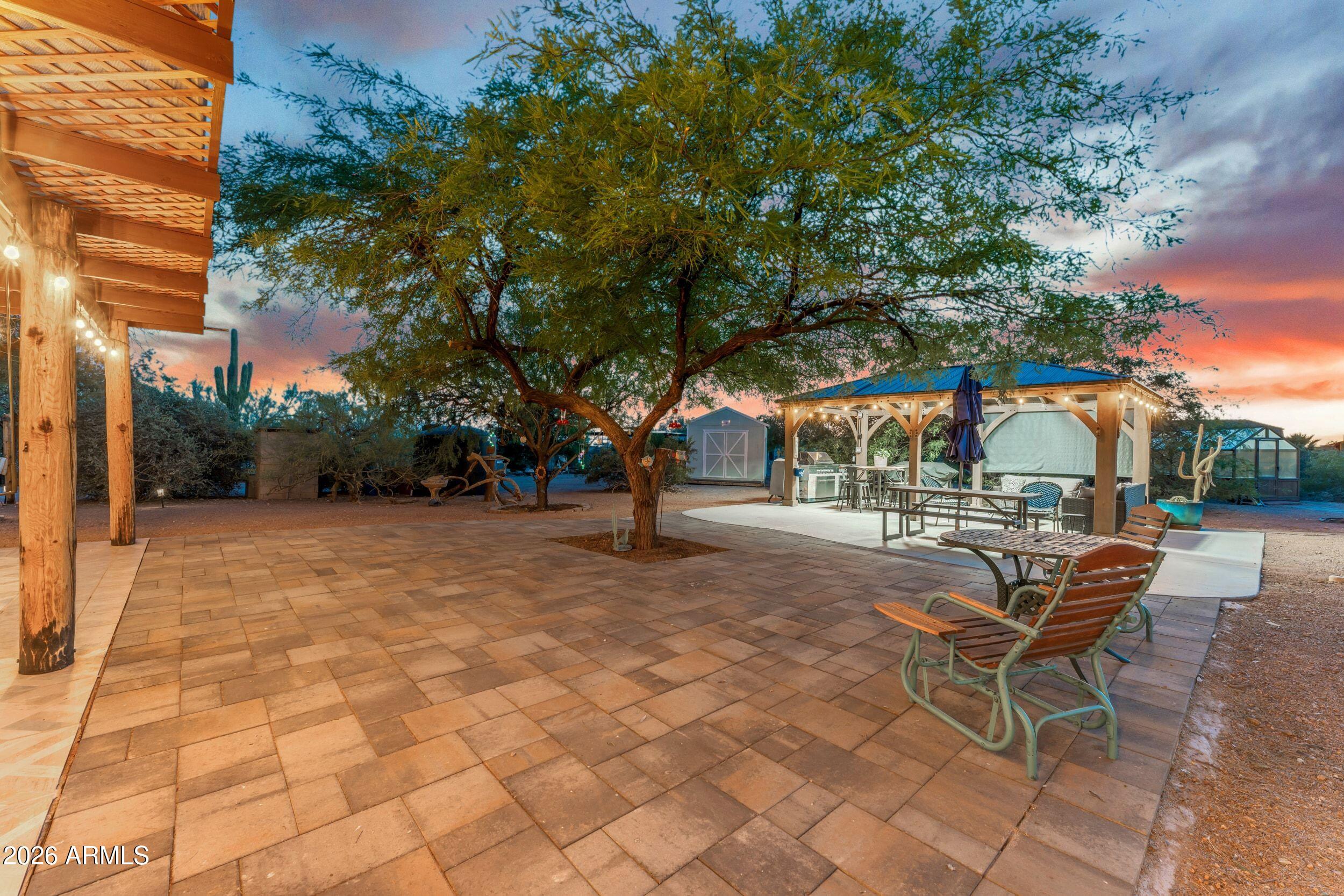 4284 North Colt Road Apache Junction, AZ 85119 - Photo 16 of 92 a view of a patio with a table and chairs under an umbrella