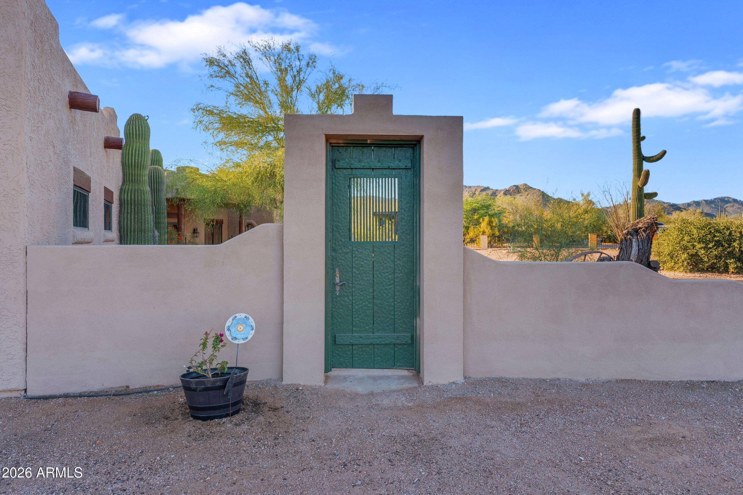 4284 North Colt Road Apache Junction, AZ 85119 - Photo 19 of 92 a front view of a house with a garden