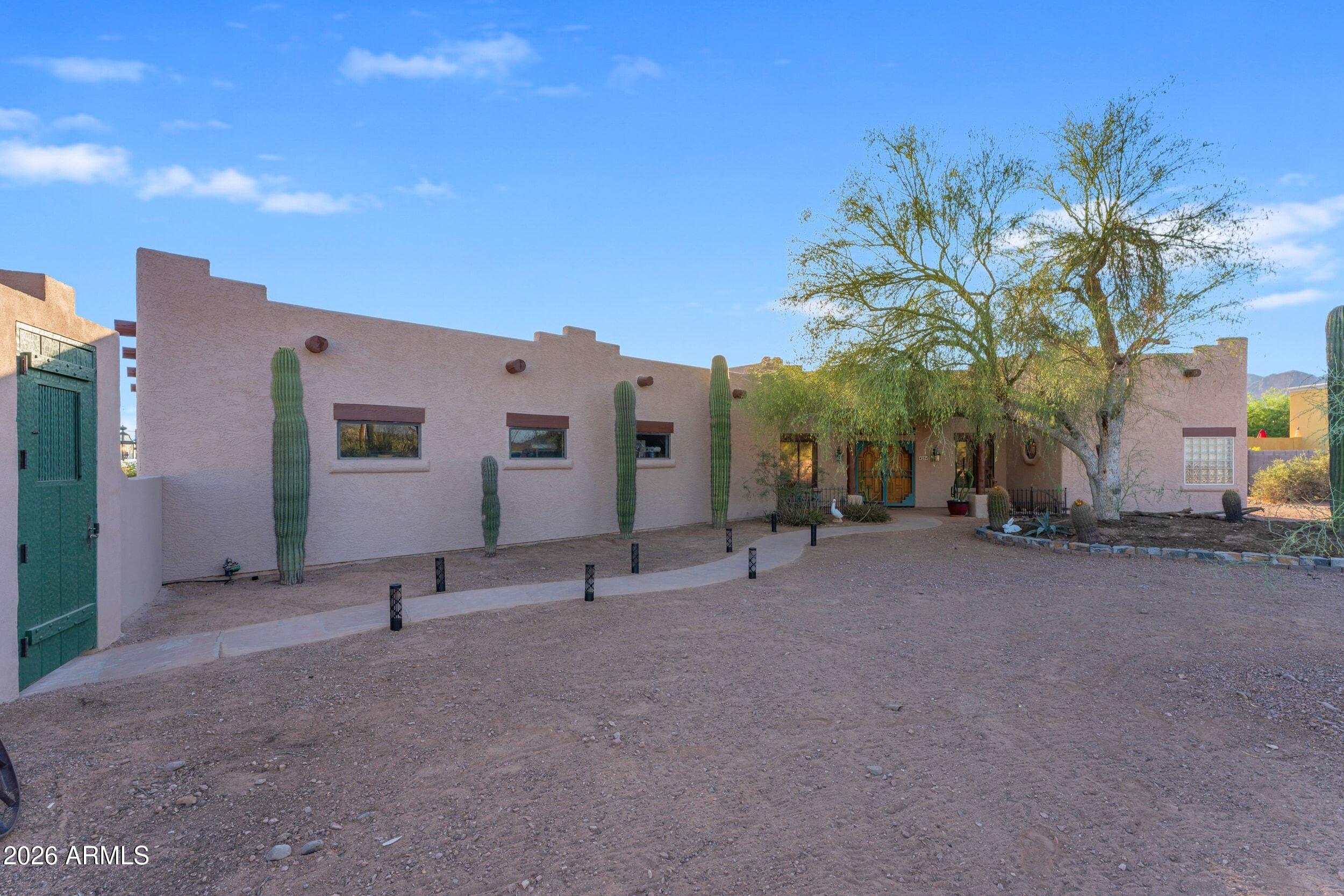 4284 North Colt Road Apache Junction, AZ 85119 - Photo 21 of 92 a view of a house with a yard and potted plants