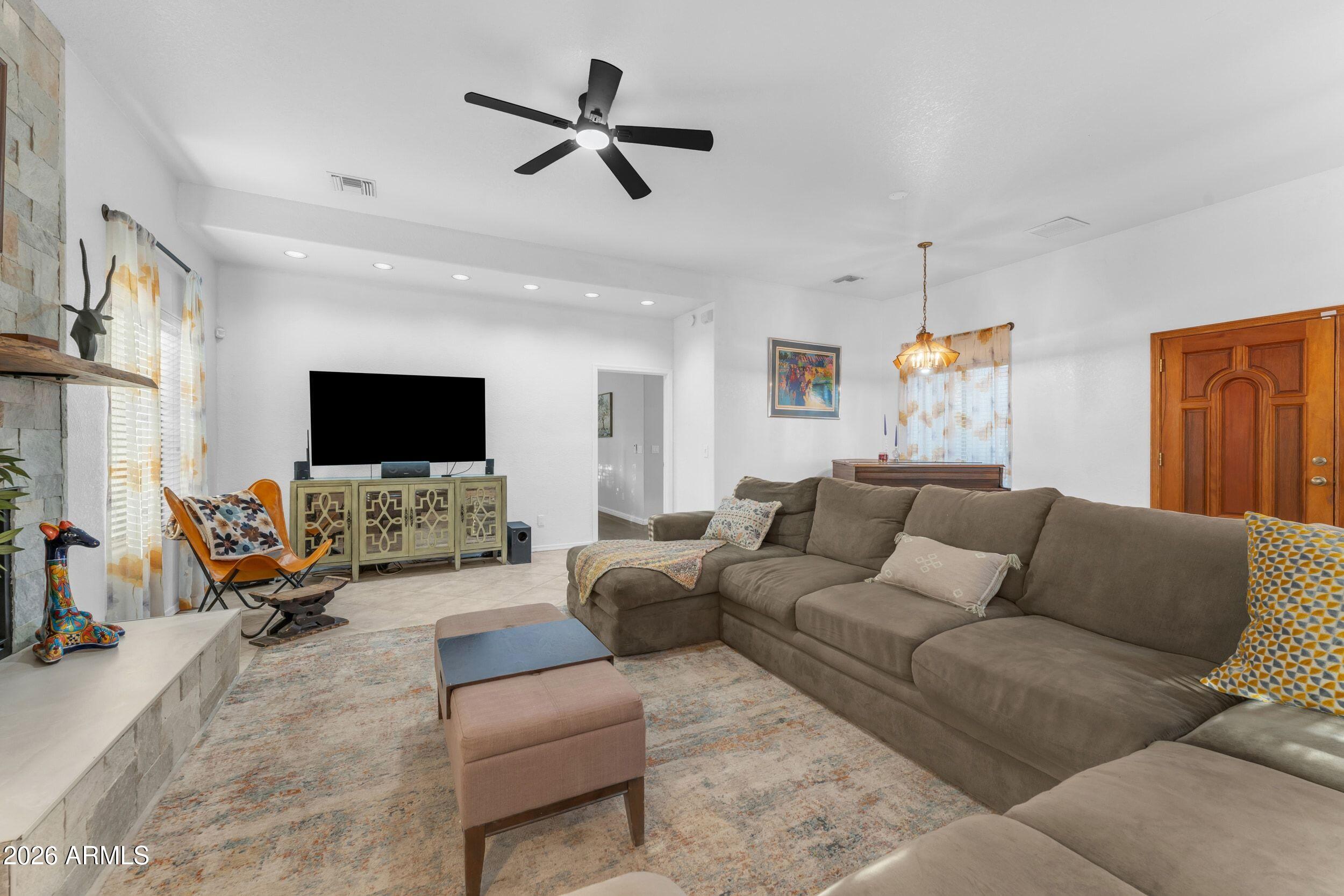 4284 North Colt Road Apache Junction, AZ 85119 - Photo 28 of 92 a living room with furniture and a flat screen tv