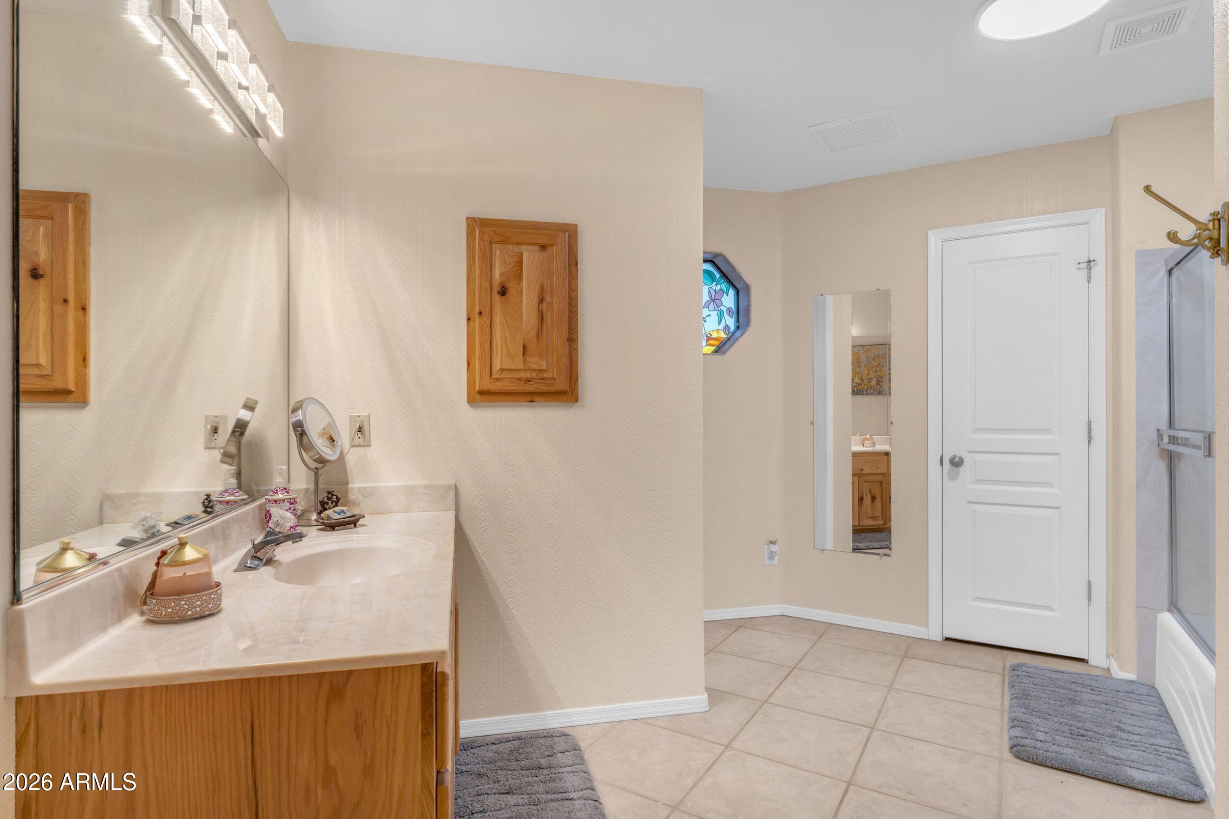 4284 North Colt Road Apache Junction, AZ 85119 - Photo 51 of 92 a bathroom with a sink vanity and a mirror