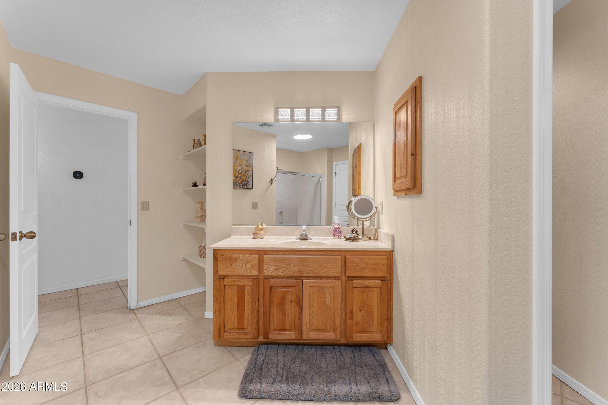 4284 North Colt Road Apache Junction, AZ 85119 - Photo 52 of 92 a spacious bathroom with a sink and a mirror