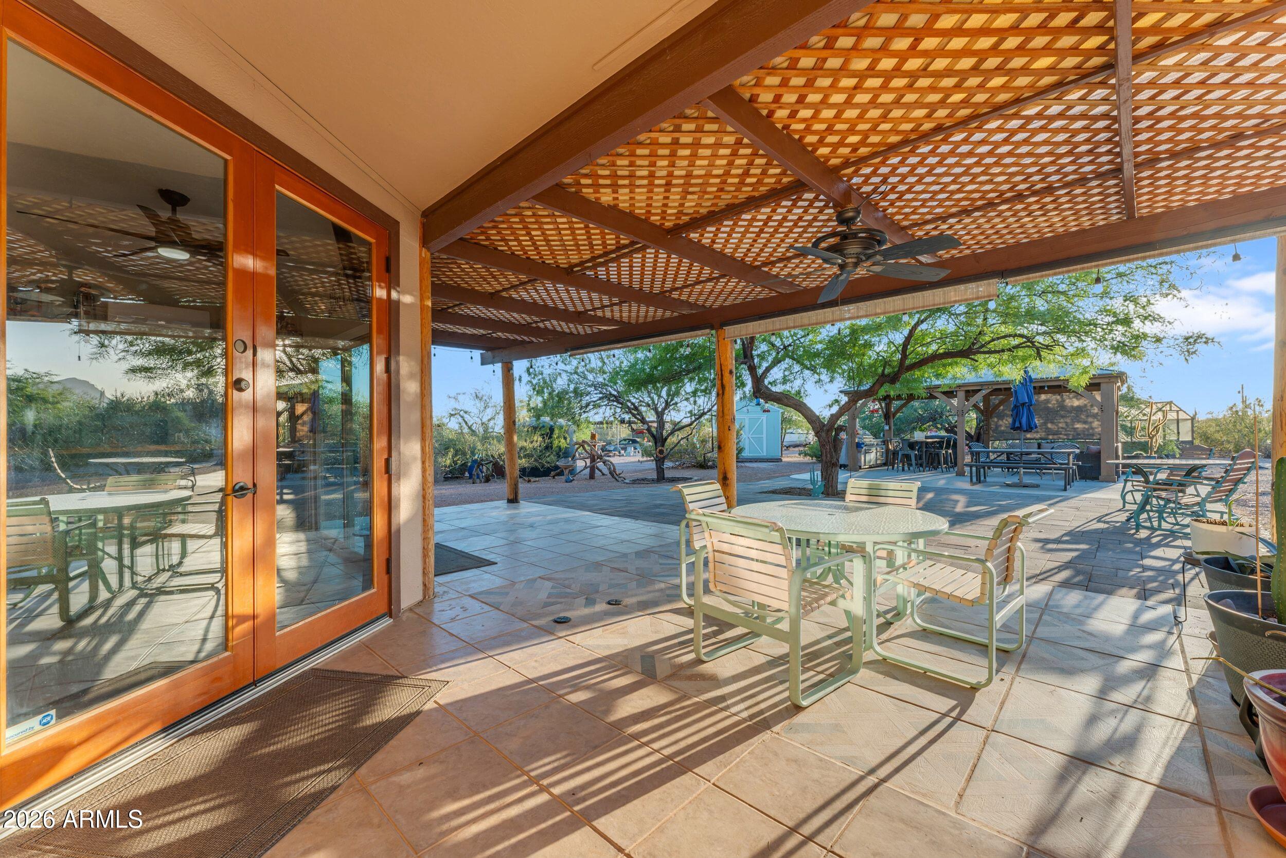 4284 North Colt Road Apache Junction, AZ 85119 - Photo 61 of 92 a view of a patio with a table and chairs under an umbrella