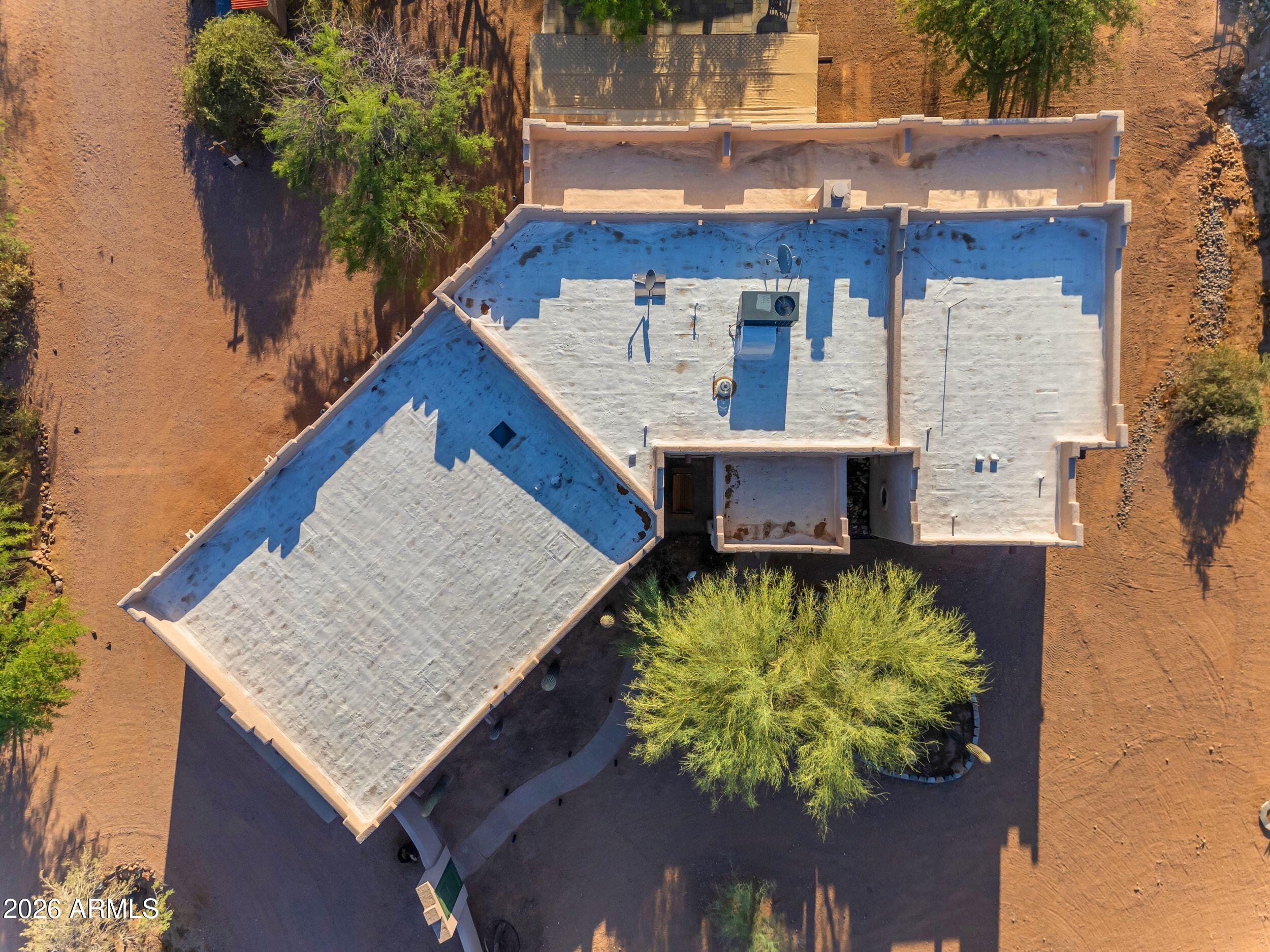 4284 North Colt Road Apache Junction, AZ 85119 - Photo 91 of 92 an aerial view of a house with a yard and large trees