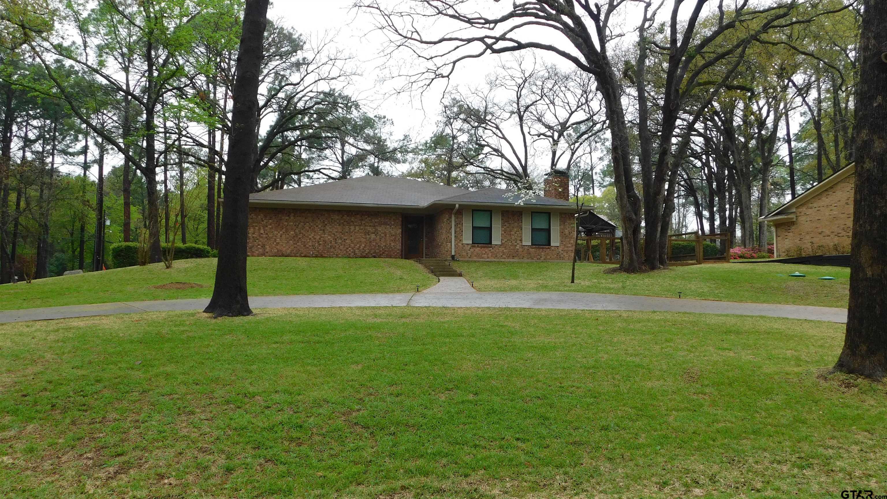 1360 Bridle Path Lane Hideaway, TX 75771 - Photo 1 of 16 a front view of a house with yard and green space