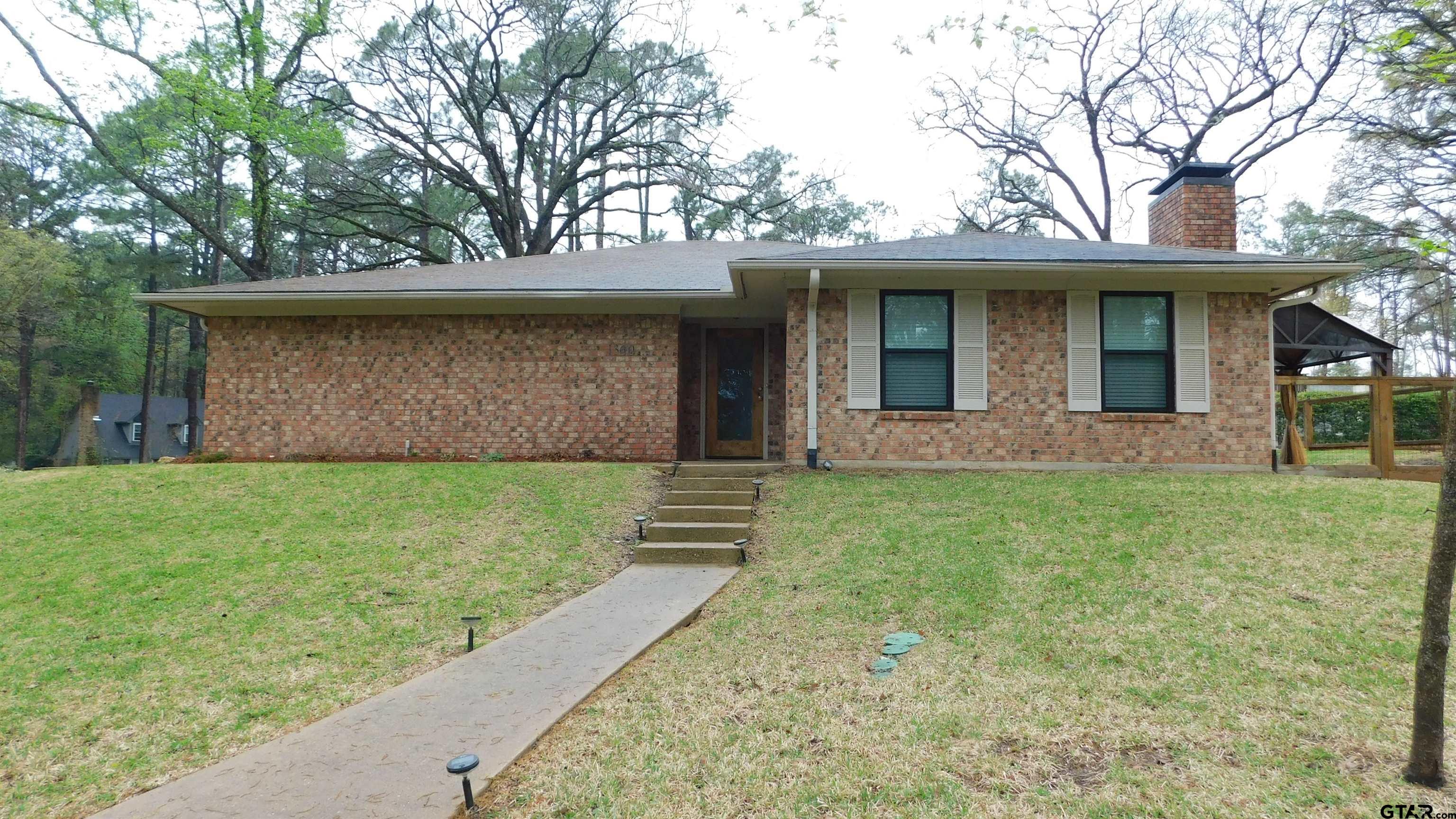 1360 Bridle Path Lane Hideaway, TX 75771 - Photo 2 of 16 a front view of a house with garden