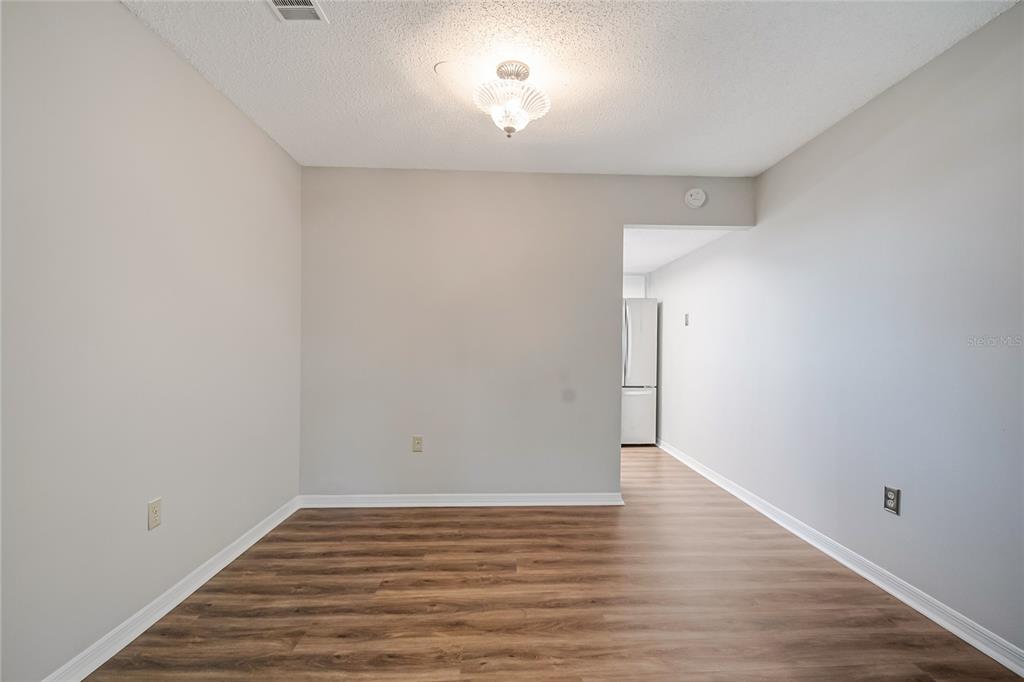 500 Newell Hill Road, Unit 106D Leesburg, FL 34748 - Photo 12 of 45 a view of empty room with wooden floor