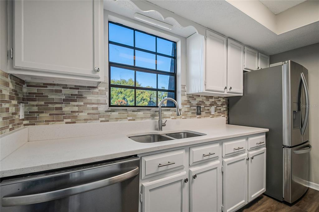 500 Newell Hill Road, Unit 106D Leesburg, FL 34748 - Photo 14 of 45 a kitchen with a refrigerator and a sink