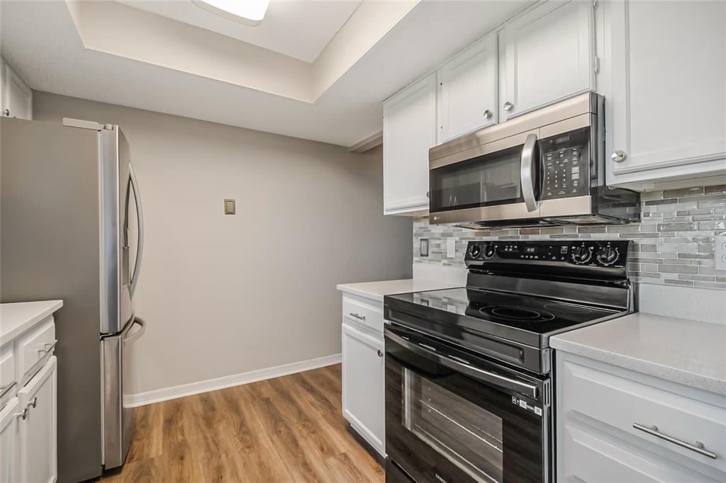 500 Newell Hill Road, Unit 106D Leesburg, FL 34748 - Photo 17 of 45 a kitchen with cabinets and steel appliances