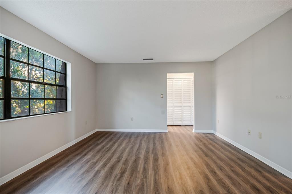 500 Newell Hill Road, Unit 106D Leesburg, FL 34748 - Photo 18 of 45 wooden floor in an empty room with a window
