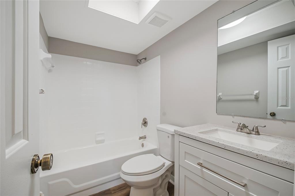 500 Newell Hill Road, Unit 106D Leesburg, FL 34748 - Photo 25 of 45 a bathroom with a granite countertop sink a toilet and shower