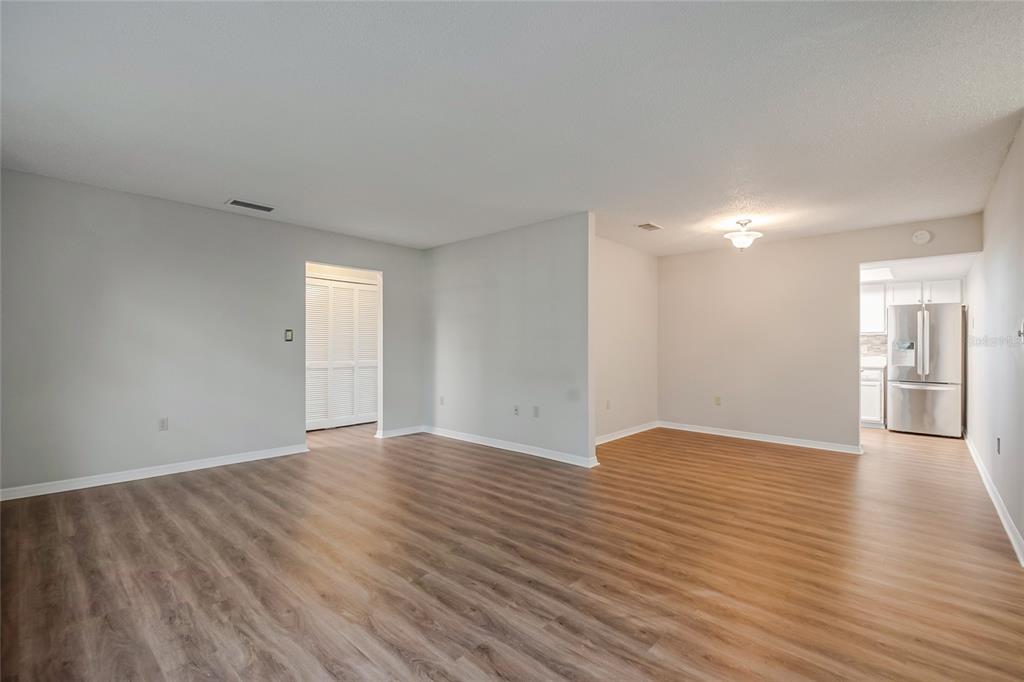 500 Newell Hill Road, Unit 106D Leesburg, FL 34748 - Photo 7 of 45 a view of an empty room with wooden floor