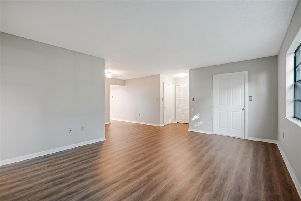 500 Newell Hill Road, Unit 106D Leesburg, FL 34748 - Photo 8 of 45 a view of an empty room with wooden and a window