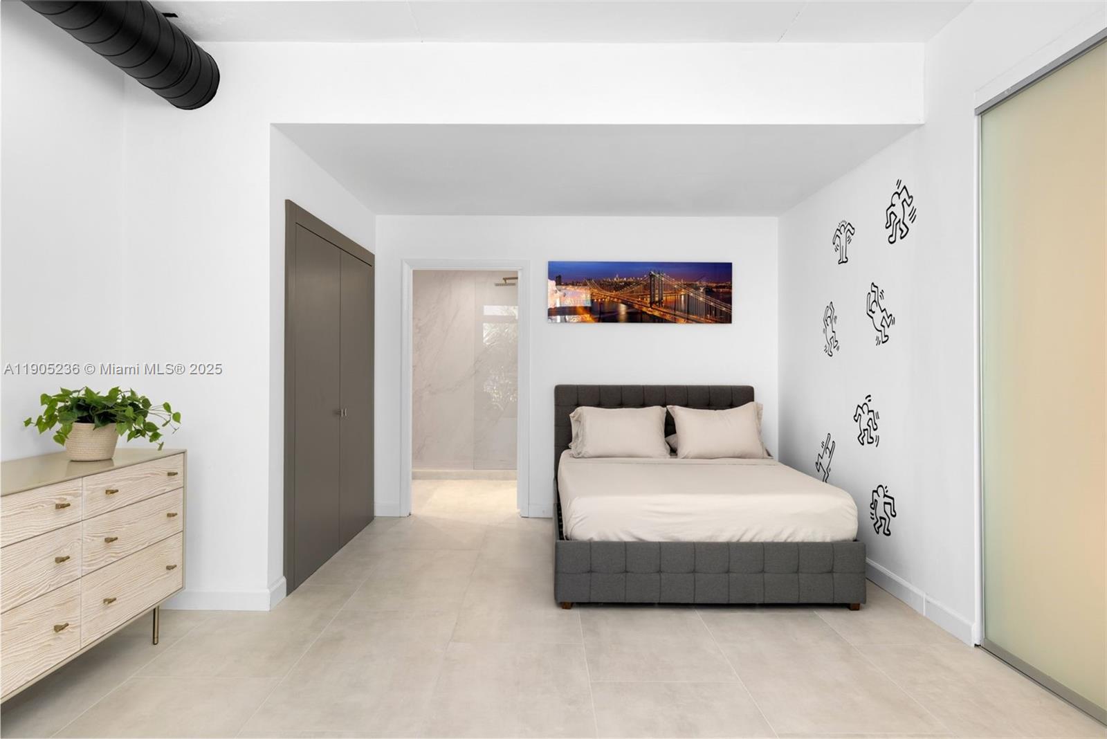 2001 Meridian Avenue, Unit 327 Miami Beach, FL 33139 - Photo 11 of 15 a bedroom with a bed and a potted plant