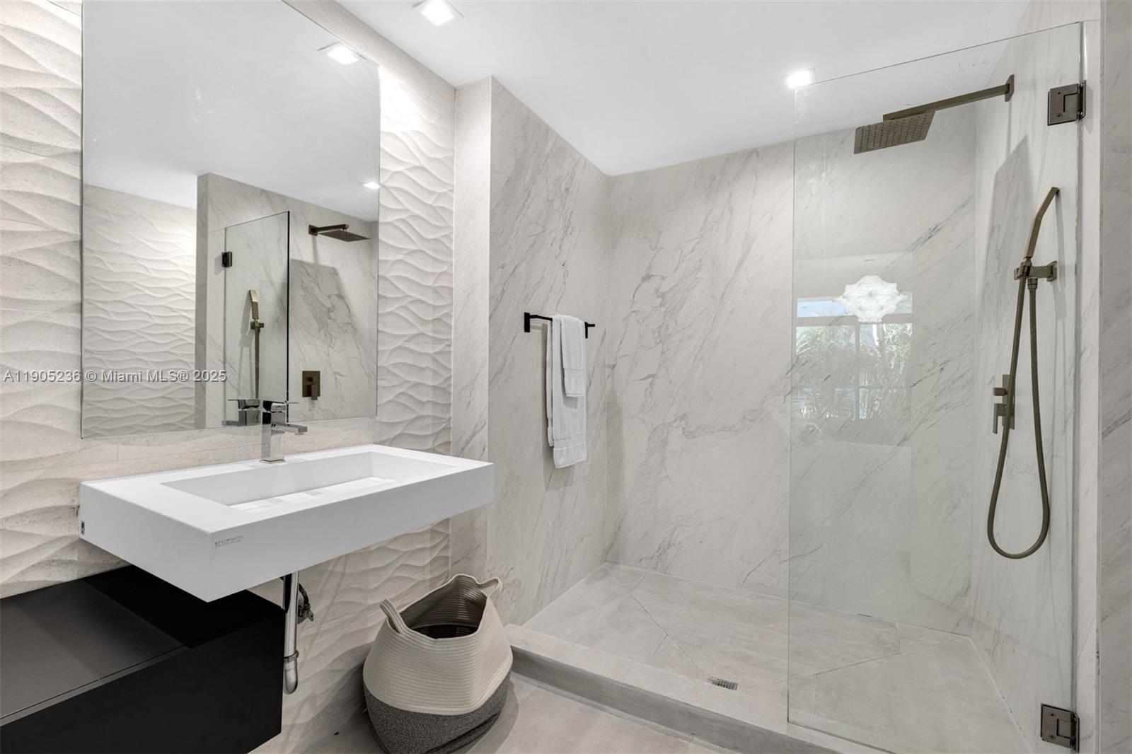 2001 Meridian Avenue, Unit 327 Miami Beach, FL 33139 - Photo 12 of 15 a bathroom with a sink a toilet and shower