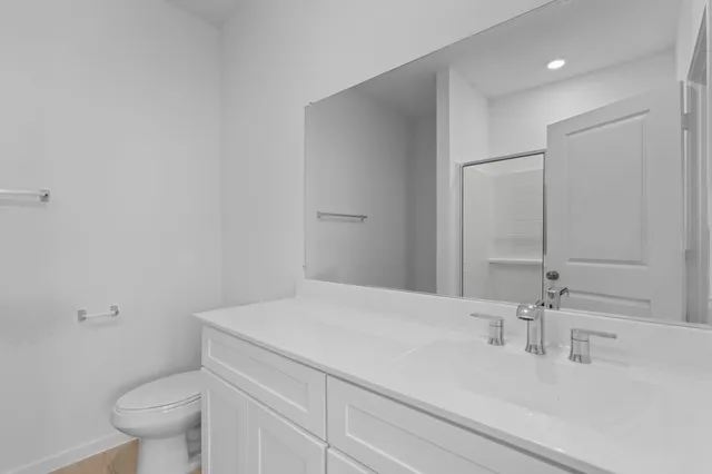 a bathroom with a sink toilet and vanity