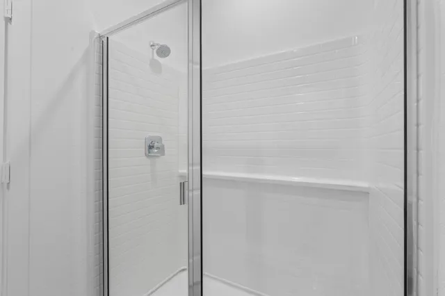 a bathroom with a glass shower door