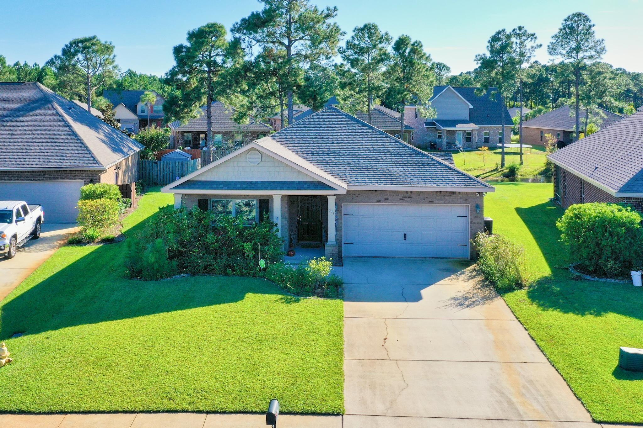 376 Pin Oak Loop Santa Rosa Beach, FL 32459 - Photo 1 of 1 a house view with a garden space