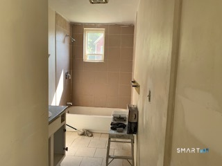 426 Union Avenue, Unit 2 Bridgeport, CT 06607 - Photo 11 of 19 a bathroom with a tub shower and sink
