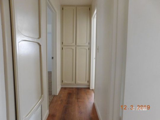 613 Ginger Avenue Ridgecrest, CA 93555 - Photo 6 of 9 a view of a hallway with wooden floor