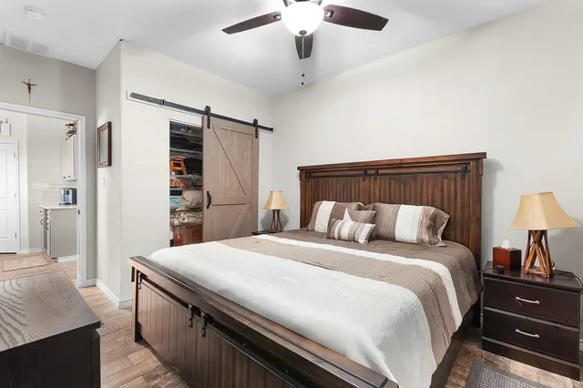 a spacious bedroom with a bed and a chandelier