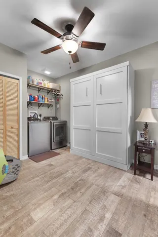 a view of a livingroom with furniture and a ceiling fan