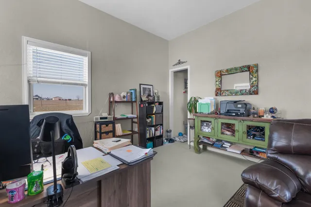 a view of a workspace with furniture and toys