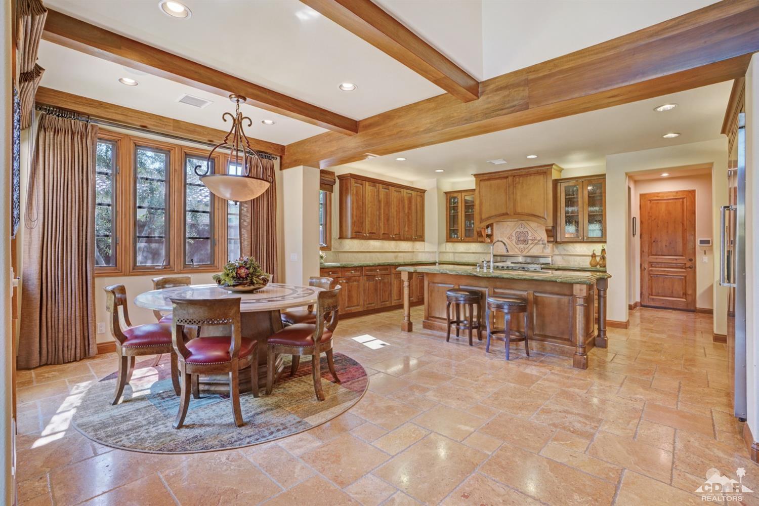 41 Cassis Circle Rancho Mirage, CA 92270 - Photo 13 of 68 a dining hall with stainless steel appliances kitchen island granite countertop furniture and a large window
