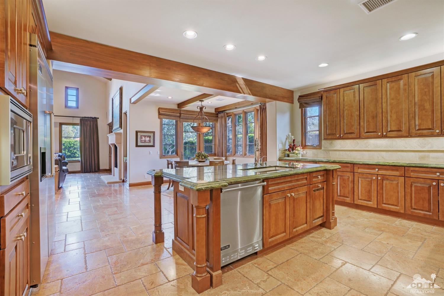 41 Cassis Circle Rancho Mirage, CA 92270 - Photo 15 of 68 a kitchen with granite countertop a stove and cabinets