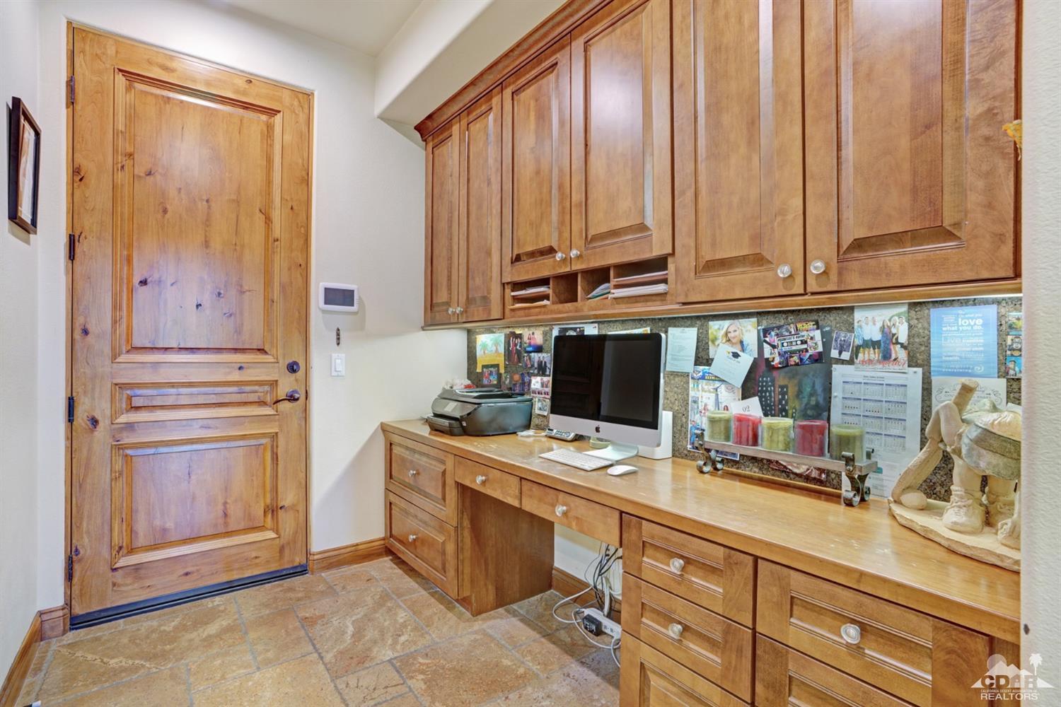 41 Cassis Circle Rancho Mirage, CA 92270 - Photo 17 of 68 a kitchen with stainless steel appliances a stove top oven and cabinets