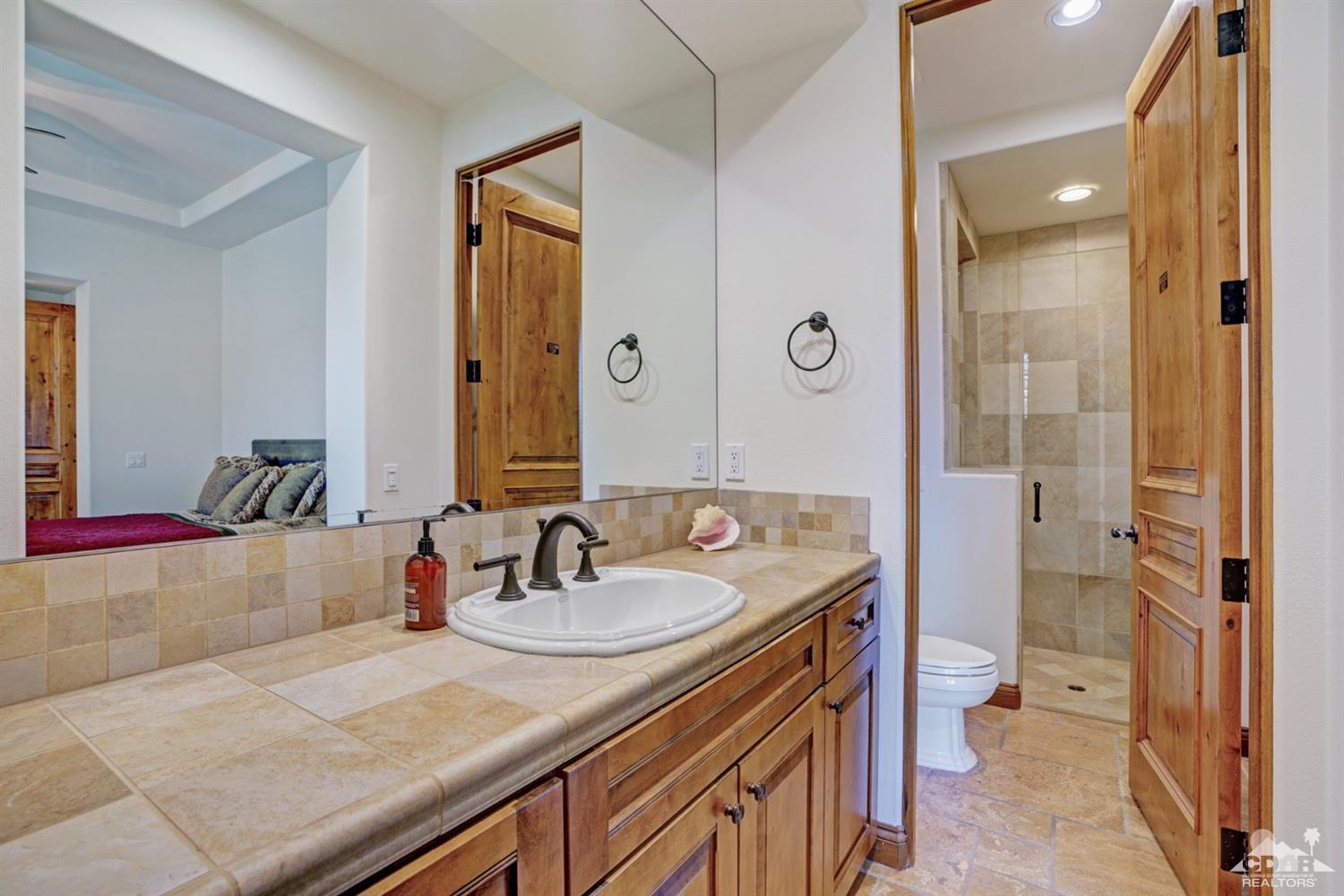 41 Cassis Circle Rancho Mirage, CA 92270 - Photo 32 of 68 a bathroom with a sink and a mirror