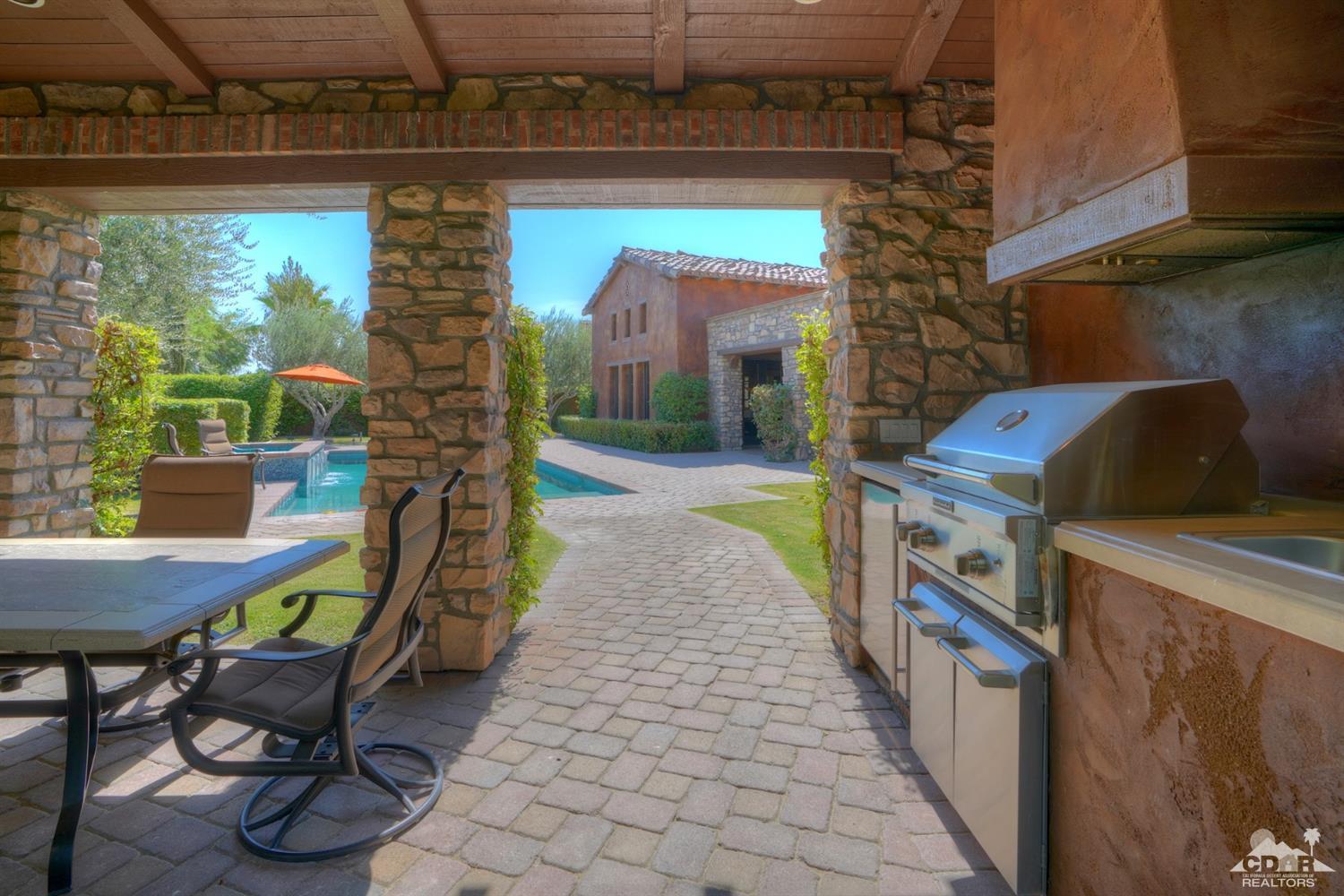 41 Cassis Circle Rancho Mirage, CA 92270 - Photo 43 of 68 a view of a patio with table and chairs potted plants with wooden floor