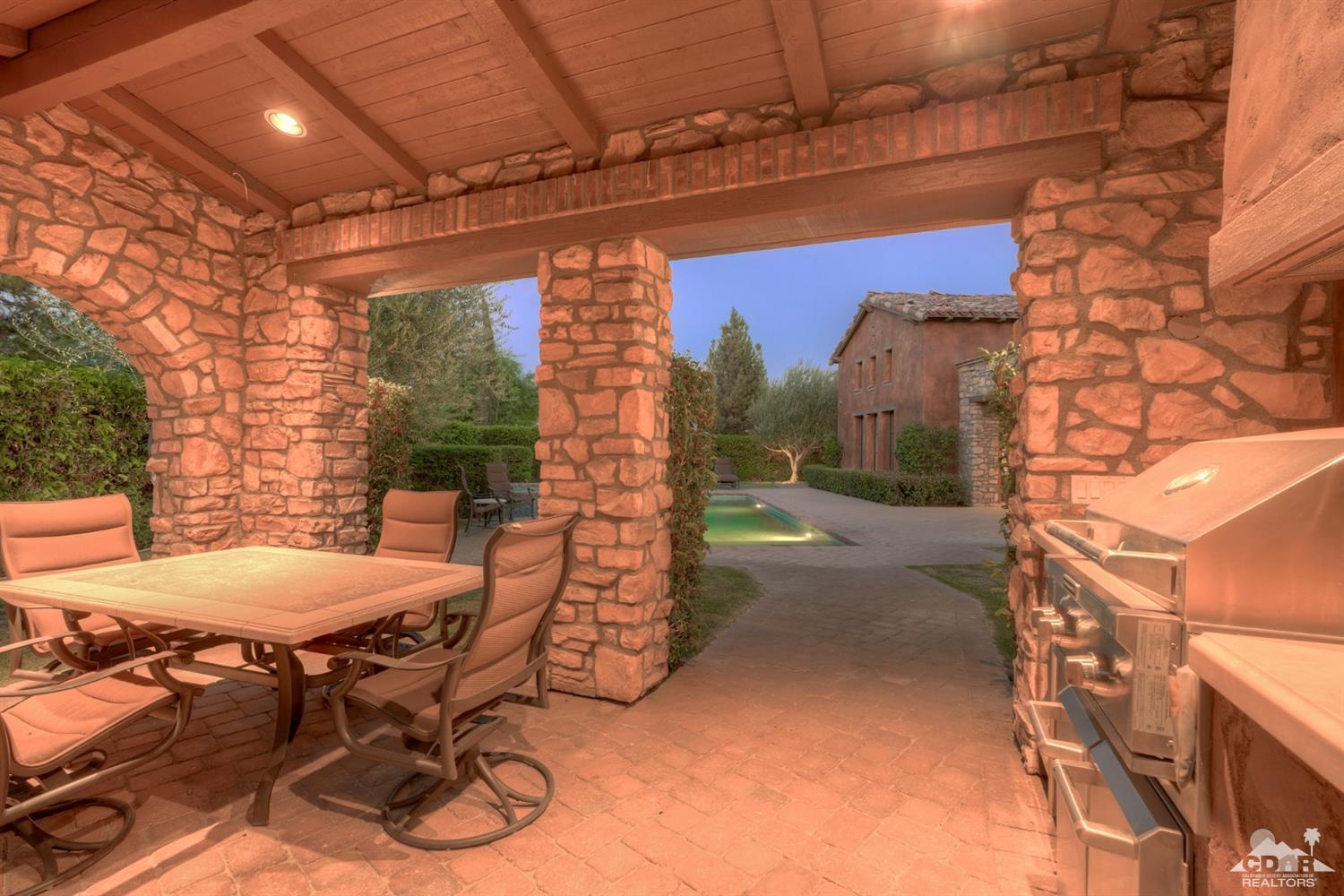 41 Cassis Circle Rancho Mirage, CA 92270 - Photo 60 of 68 a view of a patio with table and chairs with wooden floor and fence