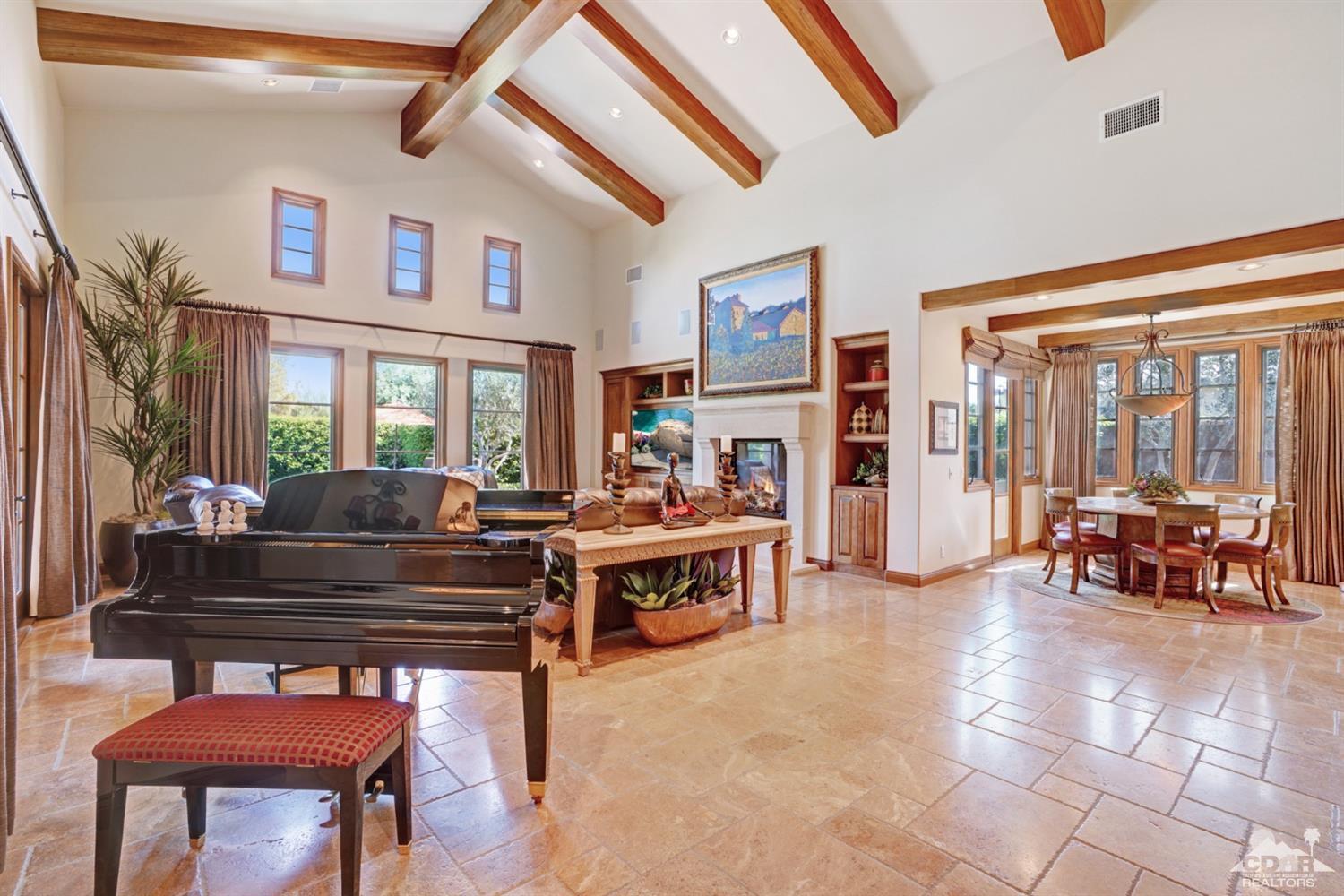 41 Cassis Circle Rancho Mirage, CA 92270 - Photo 8 of 68 a living room with furniture a fireplace and a large window