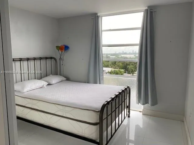 a bathroom with a sink and mirror with bathtub