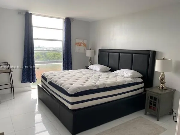 a large white bed in a small room