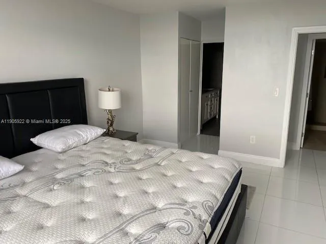 a bathroom with a granite countertop toilet and a sink