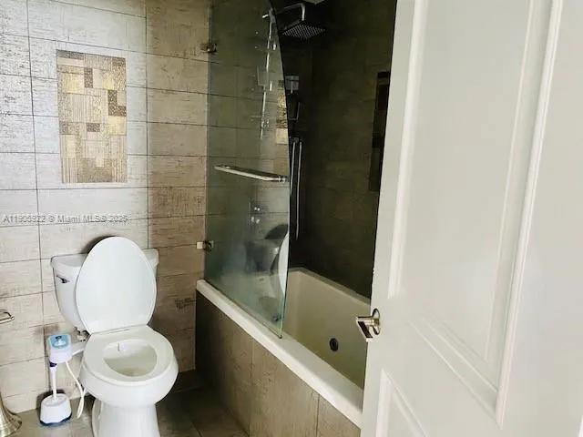 a living room with furniture and a washer dryer