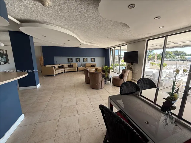 a outdoor space with lots of chairs and chandelier